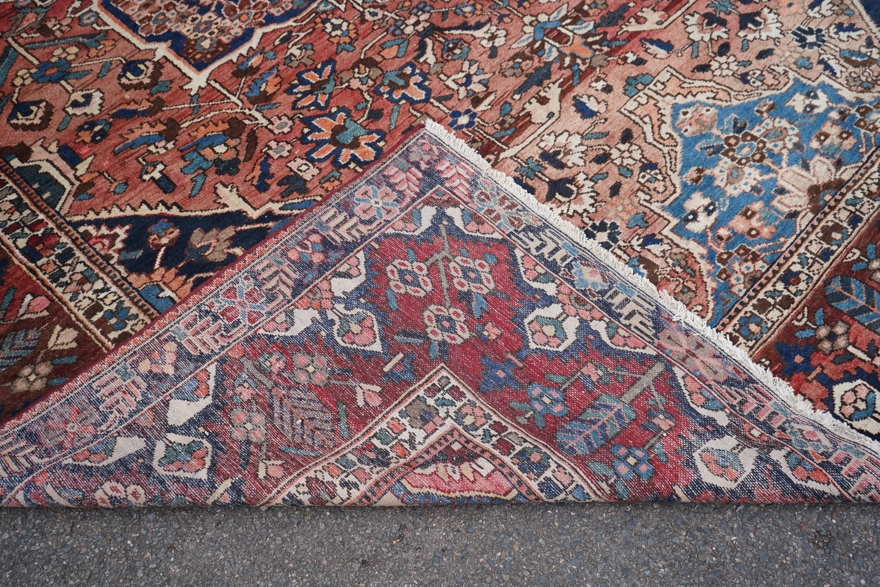 A Heriz brick red ground carpet